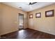This bedroom features hardwood floors, a ceiling fan, and wood windows with wooden shutters at 9515 E Julep Cir, Mesa, AZ 85207