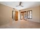 Bedroom featuring a ceiling fan and shuttered doors to a balcony, with access to another room at 9515 E Julep Cir, Mesa, AZ 85207