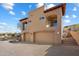 This home features a two-car garage, stucco siding, a tile roof, and multiple balconies at 9515 E Julep Cir, Mesa, AZ 85207
