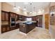 Modern kitchen featuring stainless steel appliances, dark wood cabinetry, and a center island at 9515 E Julep Cir, Mesa, AZ 85207