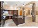 Kitchen featuring stainless steel appliances, dark wood cabinetry, and center island at 9515 E Julep Cir, Mesa, AZ 85207