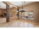 Bright living room featuring stone accents, a large chandelier, and outdoor views at 9515 E Julep Cir, Mesa, AZ 85207