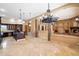 Expansive living room with stone accents, modern lighting, and dark wood cabinets at 9515 E Julep Cir, Mesa, AZ 85207