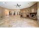 Spacious living room with stone fireplace, tile floors, and plenty of natural light at 9515 E Julep Cir, Mesa, AZ 85207