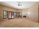 Open living room showcasing a stone fireplace and shuttered doors for natural light at 9515 E Julep Cir, Mesa, AZ 85207
