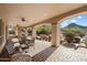 This covered patio is perfect for outdoor dining, offering views of the desert landscape and mountains beyond at 9515 E Julep Cir, Mesa, AZ 85207