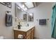 Bright bathroom with a skylight, double mirrors, and a flower vase on the sink at 1021 S Greenfield Rd # 1142, Mesa, AZ 85206