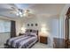 Serene bedroom with a ceiling fan, calming color palette, and matching bedside tables at 1021 S Greenfield Rd # 1142, Mesa, AZ 85206