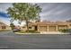 Attractive single-story home with two-car garage, neutral tones, red tile roof and green landscaping at 1021 S Greenfield Rd # 1142, Mesa, AZ 85206