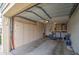 Garage interior with side storage, cabinets and full-size washer and dryer at 1021 S Greenfield Rd # 1142, Mesa, AZ 85206