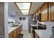 Functional kitchen design with stainless steel appliances, tiled floor and easy access to the dining area at 1021 S Greenfield Rd # 1142, Mesa, AZ 85206