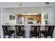 Open kitchen view with breakfast bar seating, modern stainless steel appliances, and warm wooden cabinetry at 1021 S Greenfield Rd # 1142, Mesa, AZ 85206