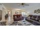 Comfortable living room with tile flooring, plush sofas, ceiling fan and open layout into the dining area at 1021 S Greenfield Rd # 1142, Mesa, AZ 85206