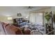 Relaxing living room with tile flooring, a ceiling fan, and sliding glass doors to the outside at 1021 S Greenfield Rd # 1142, Mesa, AZ 85206