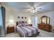 Comfortable main bedroom featuring plush carpets, neutral walls, and a decorative ceiling fan at 1021 S Greenfield Rd # 1142, Mesa, AZ 85206