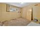 Incomplete bedroom featuring a window, damaged walls, and unfinished flooring, needing renovation and repairs at 1048 E 2Nd Pl, Mesa, AZ 85203