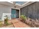 Covered front porch with a security door and a combination of brick and wood siding at 1048 E 2Nd Pl, Mesa, AZ 85203