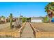 Home's exterior showcases desert landscaping and a brick walkway leading to the entrance at 1048 E 2Nd Pl, Mesa, AZ 85203