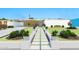 Landscaped front yard featuring a modern walkway and a covered porch with outdoor seating at 1048 E 2Nd Pl, Mesa, AZ 85203