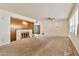 Living room with a brick fireplace, retro wood paneling, and outdated decor at 1048 E 2Nd Pl, Mesa, AZ 85203