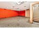 Unfinished basement features an orange wall and outdated ceiling at 1048 E 2Nd Pl, Mesa, AZ 85203