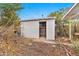 Outdoor shed with open door, presenting storage opportunities or potential workshop space in backyard at 1048 E 2Nd Pl, Mesa, AZ 85203