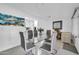 Chic dining area with a glass table, seating for six, and modern decor at 10646 W Tropicana Cir, Sun City, AZ 85351