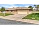 Single-story home with brick facade, attached garage, and well-maintained landscaping at 10646 W Tropicana Cir, Sun City, AZ 85351