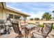 Outdoor patio area with a grill and table with six chairs, perfect for entertaining at 10646 W Tropicana Cir, Sun City, AZ 85351