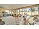 Bright sunroom featuring tile floors, a glass table, and a view of the outdoors at 10646 W Tropicana Cir, Sun City, AZ 85351