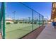 Outdoor basketball court with green surface and chain-link fencing under a clear blue sky at 10960 E Monte Ave # 286, Mesa, AZ 85209