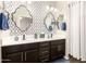 Elegant bathroom features a double sink vanity, decorative mirrors, and modern fixtures at 10960 E Monte Ave # 286, Mesa, AZ 85209