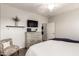 Comfortable bedroom with wood-look floors, a ceiling fan, a dresser, and a TV at 10960 E Monte Ave # 286, Mesa, AZ 85209