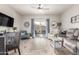 Bright living room with wood tile flooring, a ceiling fan, and glass doors to the outside at 10960 E Monte Ave # 286, Mesa, AZ 85209