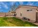 View of the backyard featuring a well-maintained lawn, patio set and privacy wall at 11330 W Eden Mckenzie Dr, Surprise, AZ 85378