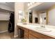 Bathroom featuring a large mirror, neutral colors, and access to a walk-in closet for storage at 11330 W Eden Mckenzie Dr, Surprise, AZ 85378