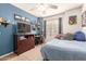 Bedroom featuring carpet, a ceiling fan, blue walls, and decor, creating a comfortable atmosphere at 11330 W Eden Mckenzie Dr, Surprise, AZ 85378