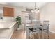 Bright dining area with a wooden table, white chairs, and a large window at 11330 W Eden Mckenzie Dr, Surprise, AZ 85378