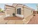 Close-up view of the side of the home showing neutral stucco and a well-manicured landscape at 11330 W Eden Mckenzie Dr, Surprise, AZ 85378