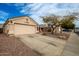 A charming home with a two-car garage and low-maintenance desert landscaping at 11330 W Eden Mckenzie Dr, Surprise, AZ 85378