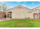 View of the back of the home, featuring stucco siding, a covered patio, and a well-maintained lawn at 11330 W Eden Mckenzie Dr, Surprise, AZ 85378