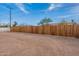 Spacious dirt backyard enclosed by a tall wooden fence providing privacy and security at 1137 E Mcmurray Blvd, Casa Grande, AZ 85122