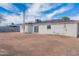 The home's backyard has a spacious dirt yard and features white brick and a metal tower at 1137 E Mcmurray Blvd, Casa Grande, AZ 85122