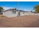 The home's backyard has a spacious dirt yard and features white brick and a metal tower at 1137 E Mcmurray Blvd, Casa Grande, AZ 85122