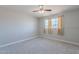 Bright bedroom with a ceiling fan, neutral carpet, and two windows providing plenty of natural light at 1137 E Mcmurray Blvd, Casa Grande, AZ 85122