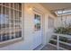 Front porch view with a white door, windows, and an outdoor light fixture at 1137 E Mcmurray Blvd, Casa Grande, AZ 85122