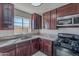 Kitchen featuring granite countertops, stainless steel appliances, and dark wood cabinets at 1137 E Mcmurray Blvd, Casa Grande, AZ 85122