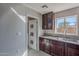 This kitchen features granite countertops, a stainless steel sink, and dark wood cabinetry at 1137 E Mcmurray Blvd, Casa Grande, AZ 85122