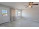 Cozy living room with tile floors, neutral paint, a ceiling fan, and natural light at 1137 E Mcmurray Blvd, Casa Grande, AZ 85122