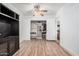 Bedroom featuring a closet, laminate flooring, and an entertainment center at 11403 N 57Th Dr, Glendale, AZ 85304